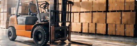 Forklift loading cartons in a warehouse